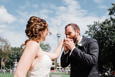 Groom Kisses Bride's Hand at Their Thompson Hotel Toronto Wedding