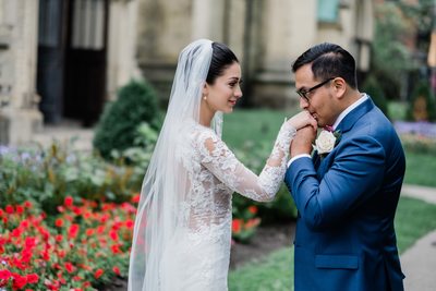 Groom Kisses Bride's Hand During Photo Shoot
