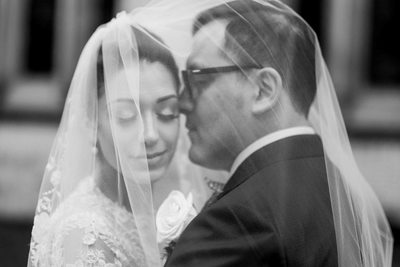 Groom Kisses Bride Under Veil