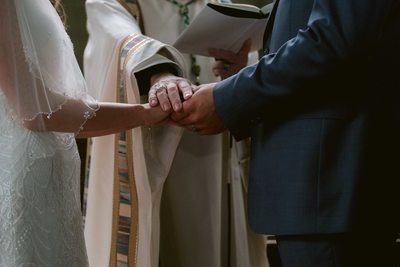 Priest Blesses Bride and Groom