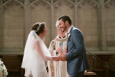 Bride and Groom Laugh after First Kiss