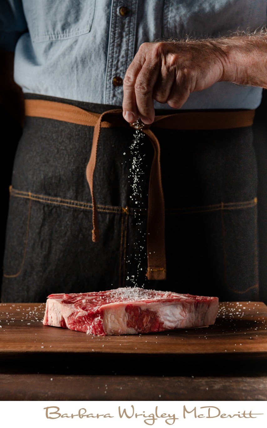 Man Salting Steak