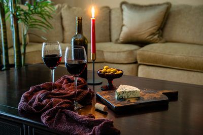 Red wine served with olives and cheese by candlelight
