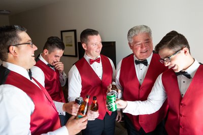 Groomsmen toast while getting ready for wedding 