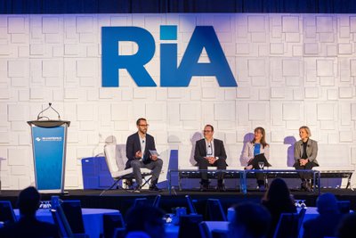 RIA Conference Panelists discussion on stage