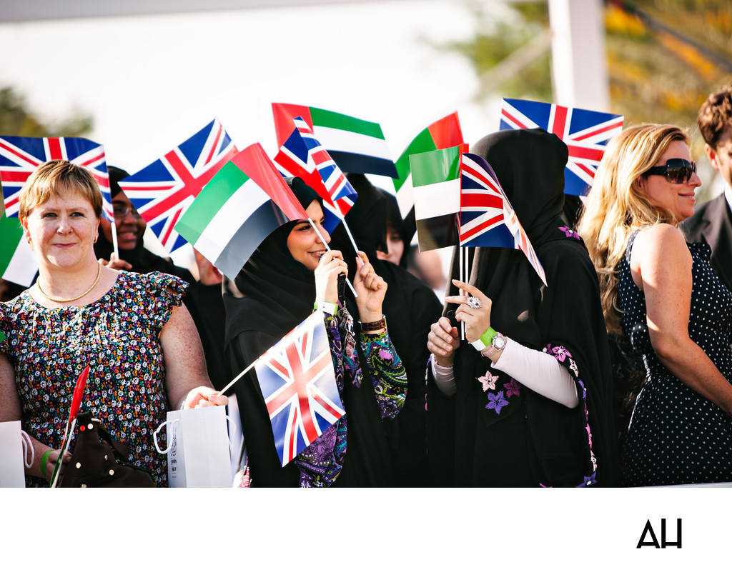 British and Emirati guests waving flags at a UAE event