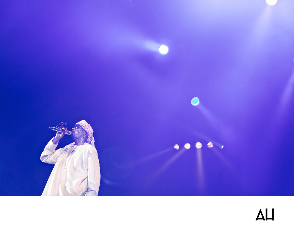 Singer Performing Under Blue Stage Lights