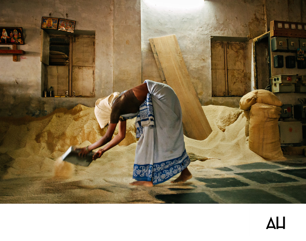 Woman Sweeping Grain Inside Rice Mill