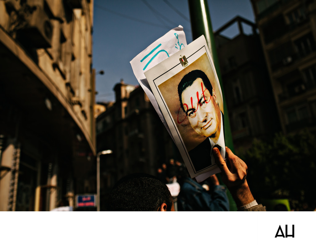 Protester Holds Defaced Mubarak Portrait