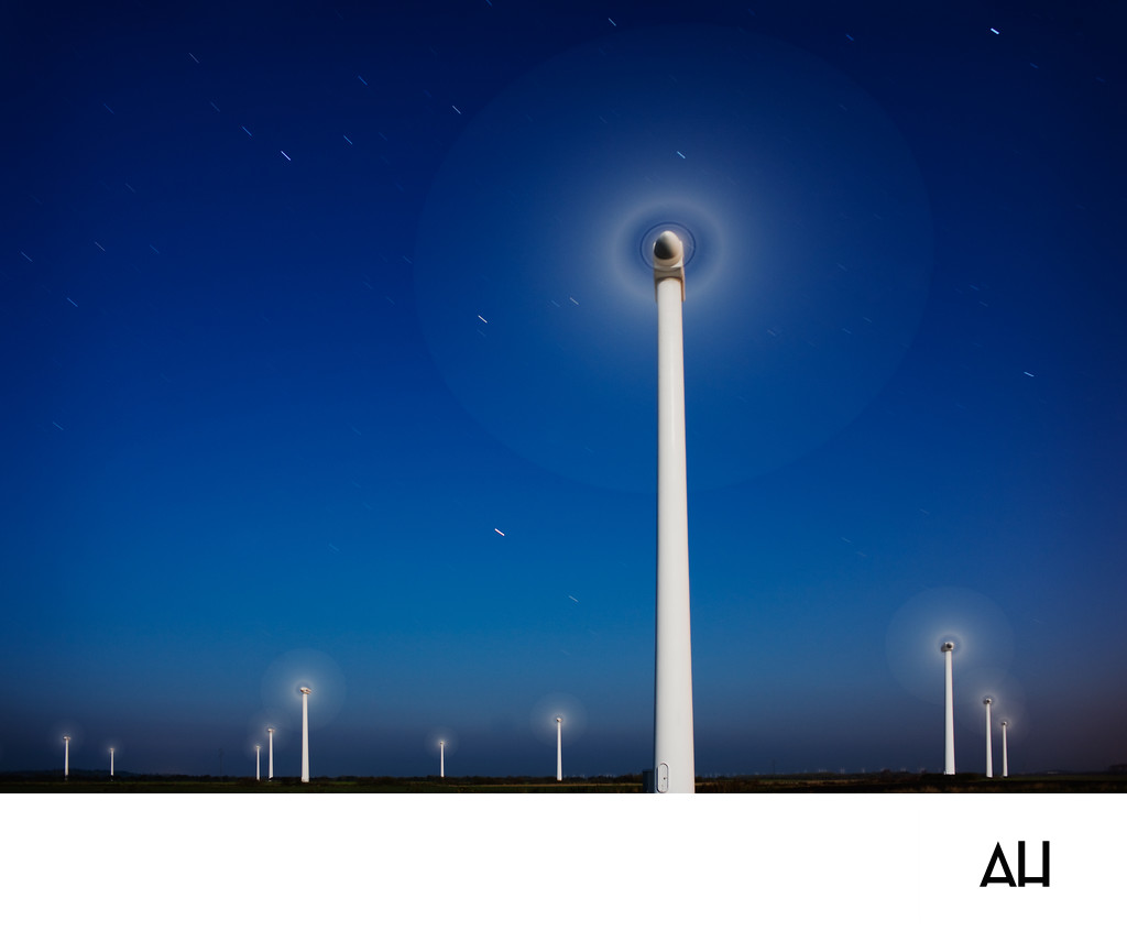 Wind Turbines Turning Under a Starry Night Sky