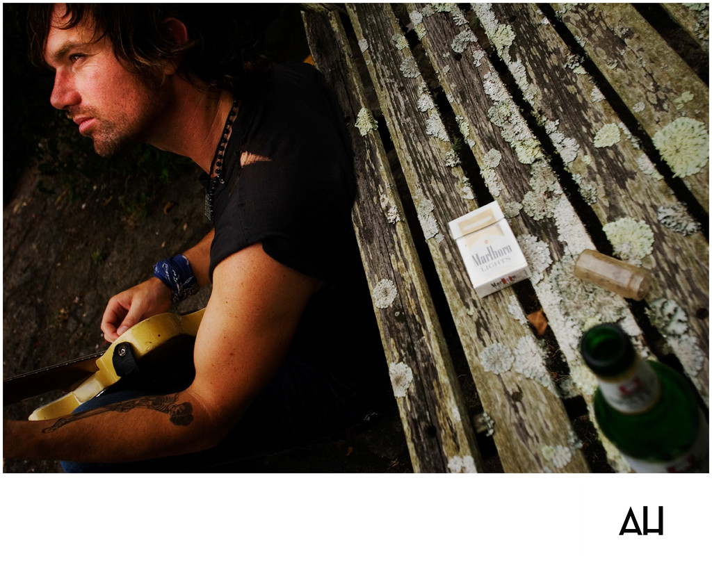 Musician Resting with His Guitar Outdoors