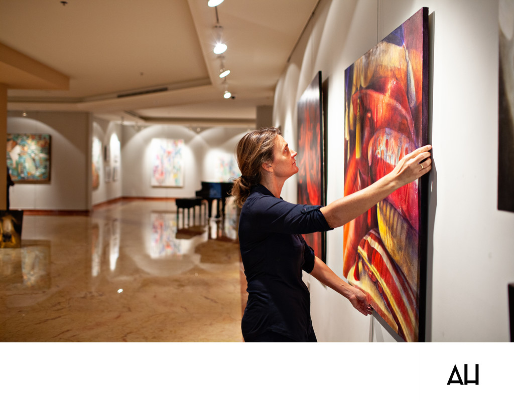 Gallery Curator Installing a Painting