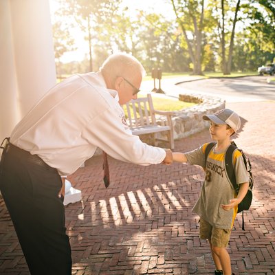 School Administrator Greeting a New Student