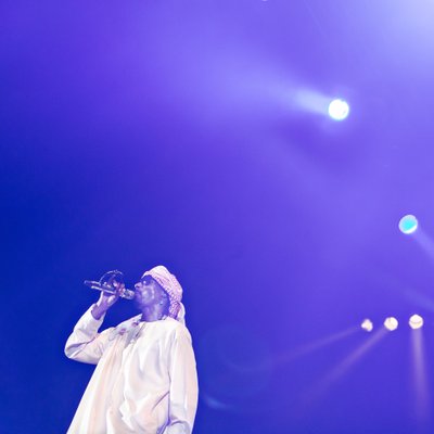 Singer Performing Under Blue Stage Lights