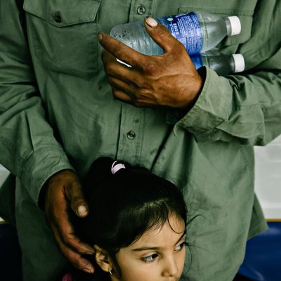 Father Protects Young Daughter in Crowd