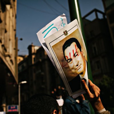 Protester Holds Defaced Mubarak Portrait