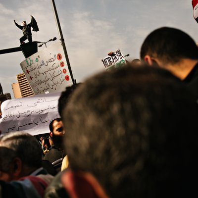 Cairo Protest Crowd with Signs and Egyptian Flag