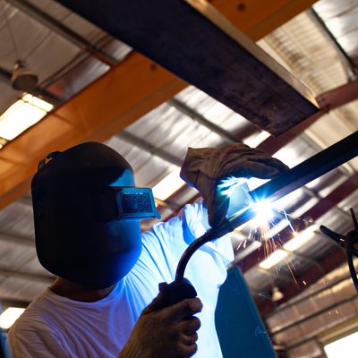 Welder Fabricating Steel in an Industrial Workshop