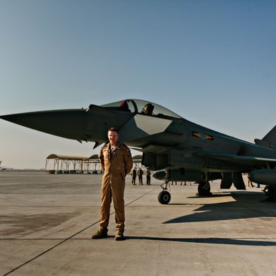 Military Pilot Standing Beside a Fighter Jet
