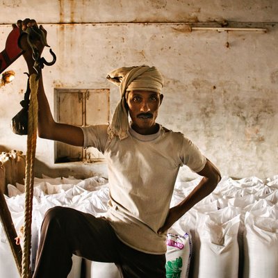 Rice Mill Worker with Hoist and Filled Sacks