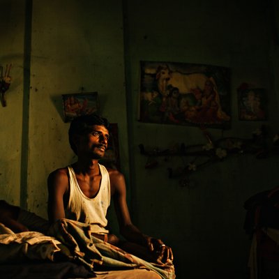 Rice Mill Worker at Home in Low Light