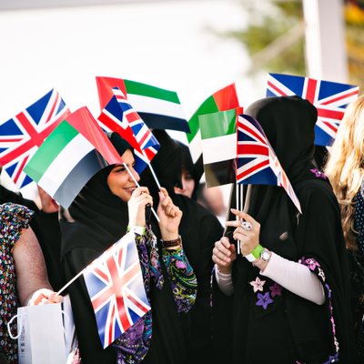 British and Emirati guests waving flags at a UAE event