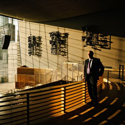 Executive Portrait in Sunlit Event Venue
