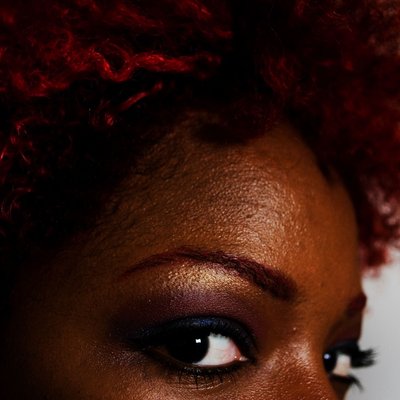 Beauty Portrait with Red Curls and Gold Makeup