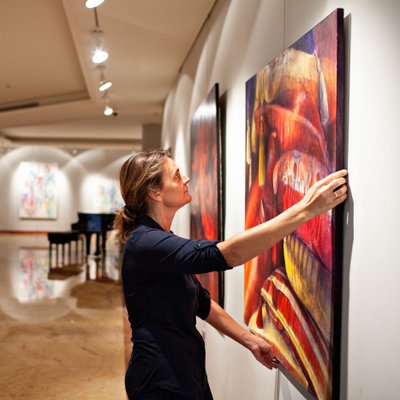 Gallery Curator Installing a Painting
