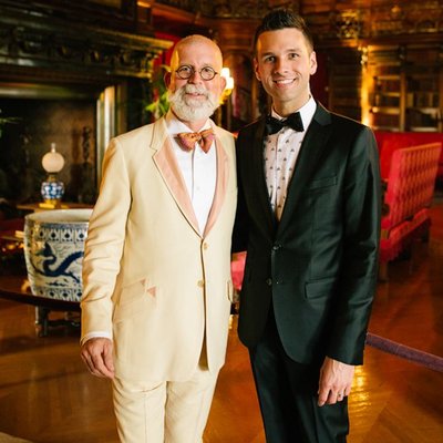 Two Men in Formalwear Inside a Historic Library