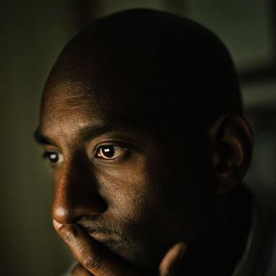 Contemplative Man in Window Light