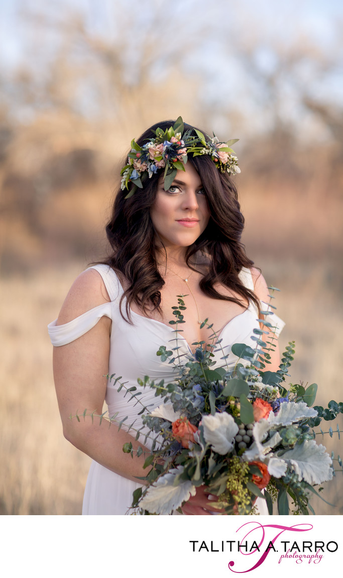 A boho bride with a flower crown and DIY bouquet