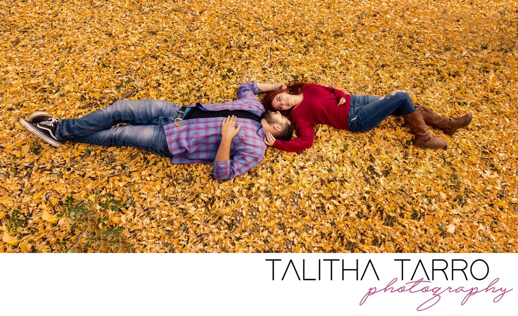 Laying in fall leaves engagement santa fe, new mexico