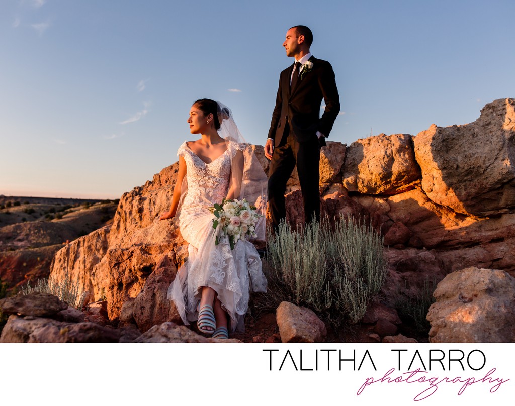 Sunset bride and groom sitting on the red rocks of Santa Fe, NM