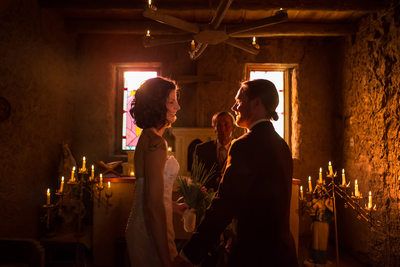 Candlelit wedding ceremony in the adobe walled chapel