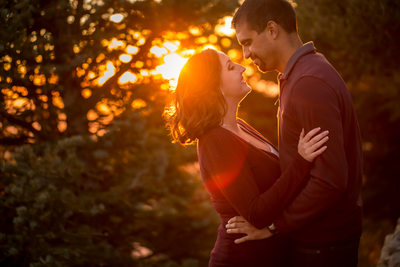 Couple hugging with sunset in the background