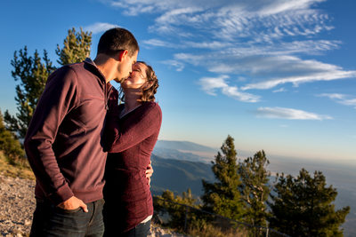 couple kissing on top of the mountain