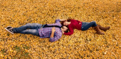 Laying in fall leaves engagement santa fe, new mexico