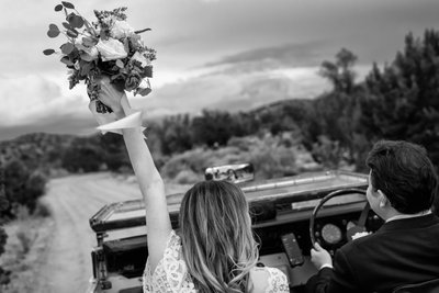 wedding bouquet in air getaway car Albuquerque