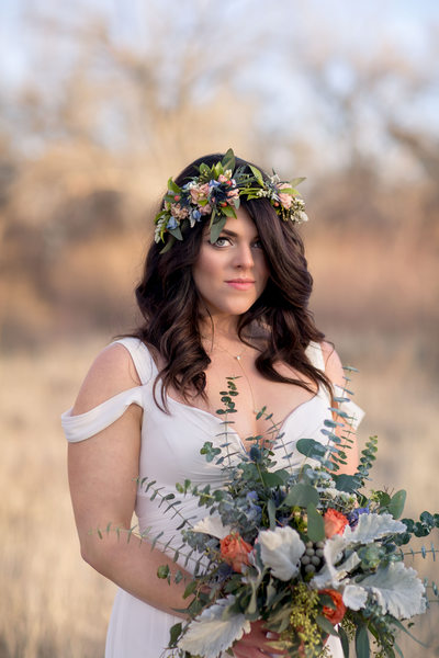 A boho bride with a flower crown and DIY bouquet