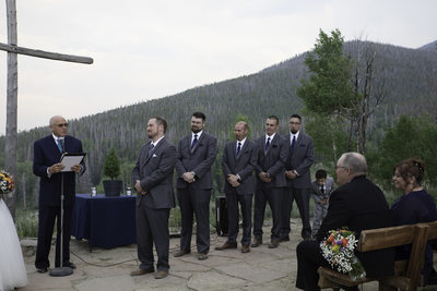 Wedding groom at the altar with groomsmen