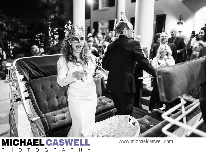 Bride and groom on carriage at Southern Oaks