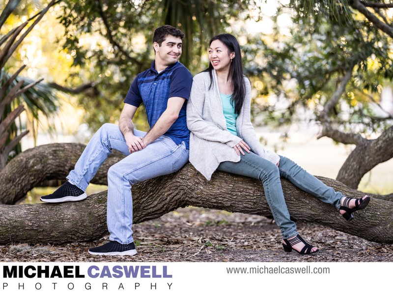 Couple Sits on Tree Branch