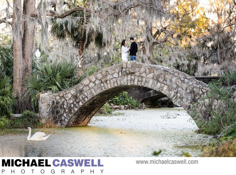 Couple on Langles Bridge with Swan in Water