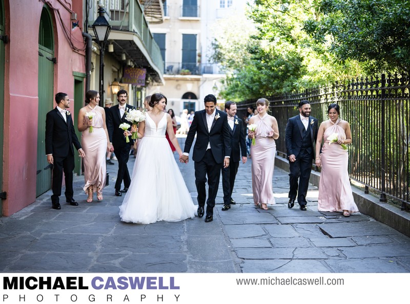 Bridal party walks through Pirate's Alley