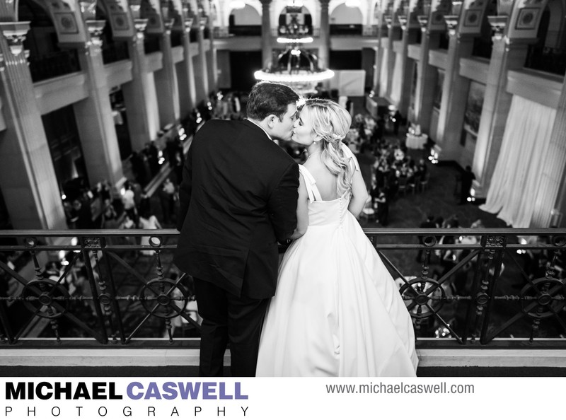 Bride and Groom Kiss on Balcony at Capital on Baronne