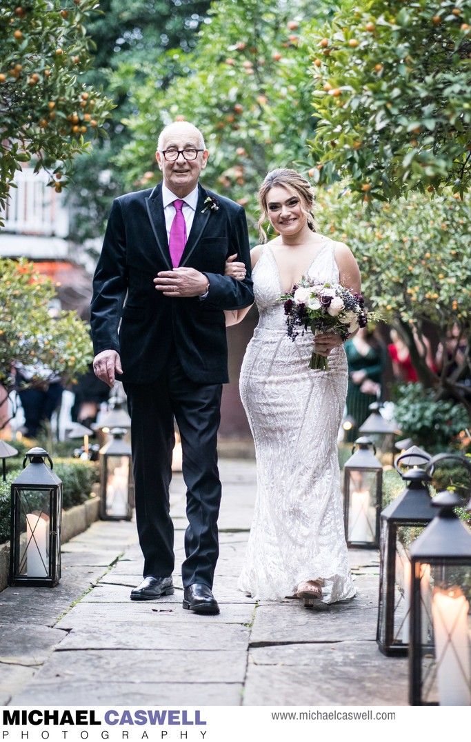 Bride and father walk down aisle at Hermann-Grima House