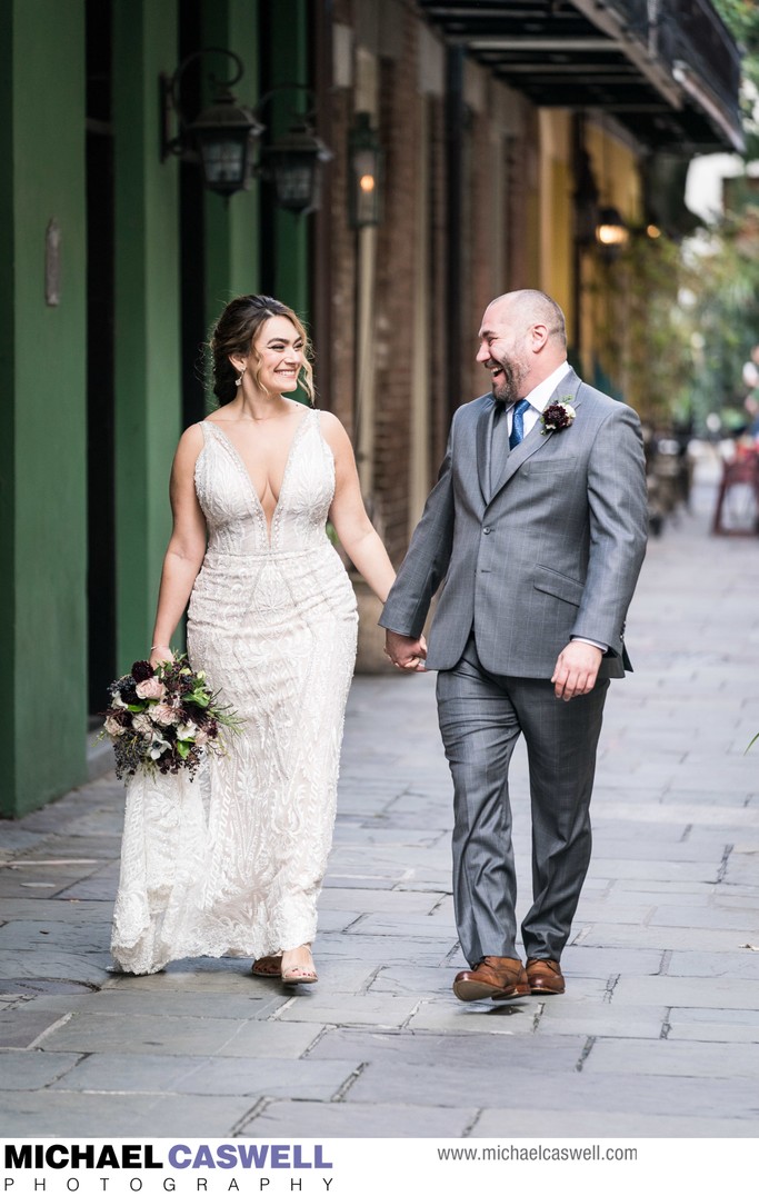 Bride and groom walk in Exchange Place in New Orleans