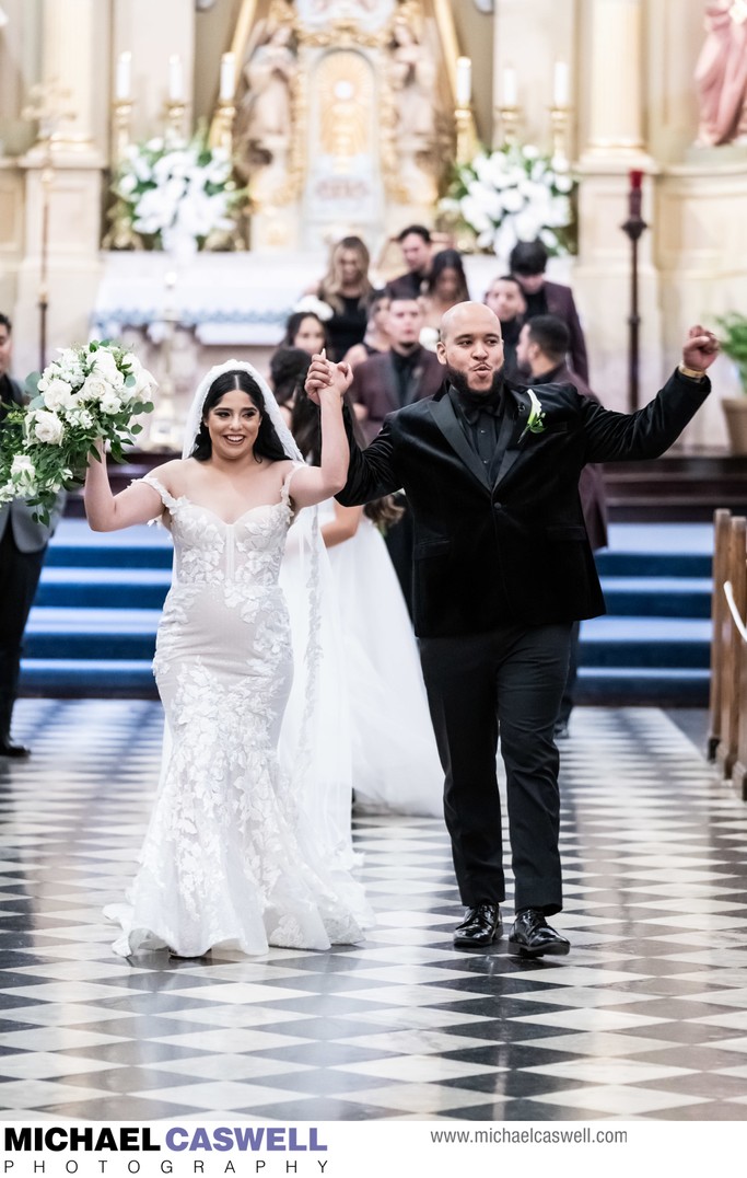 Bride and groom recess down St. Louis Cathedral aisle