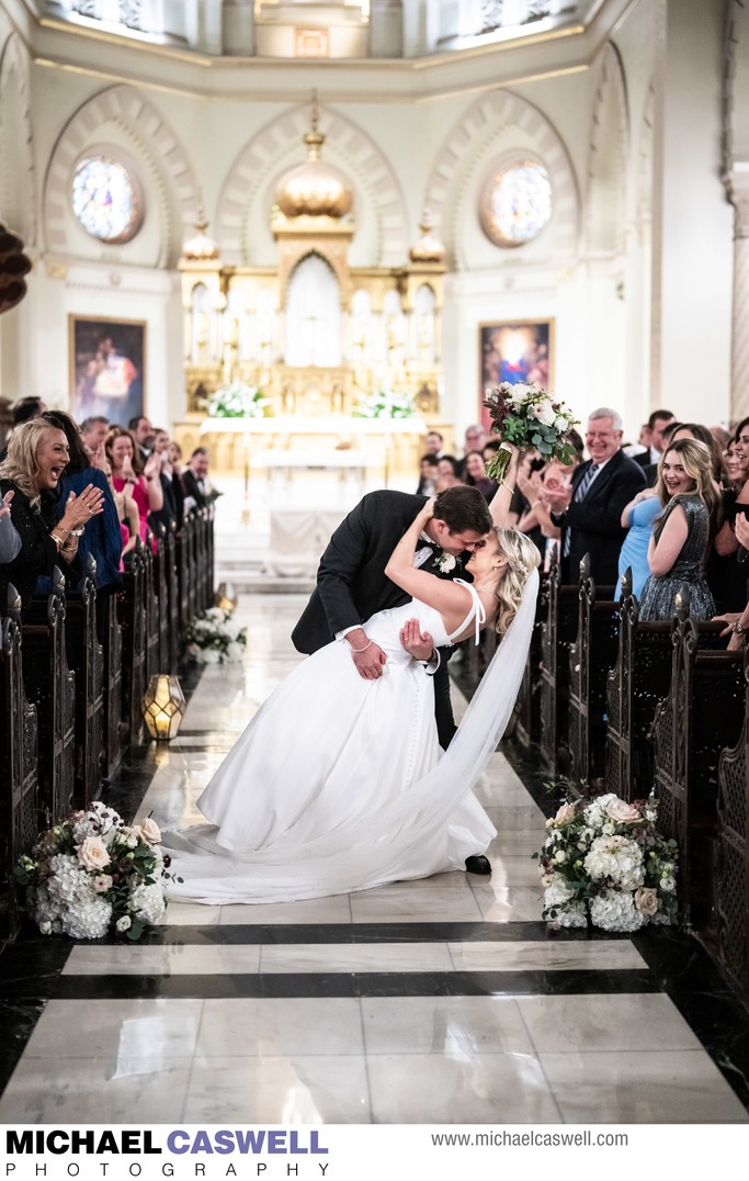 Couple Kisses at Immaculate Conception Wedding